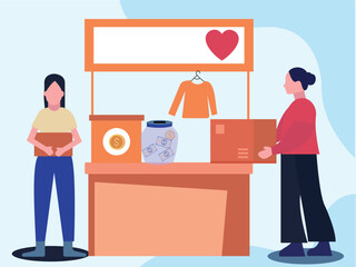 The girls are standing by the charity stall.