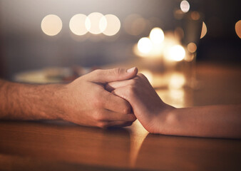 Night, support and hands of couple on table for anniversary, date and commitment in relationship....