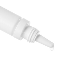 Dripping medical drops from bottle on white background