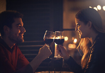 Man, woman and wine cheers for date night romance in dark with bokeh lights, restaurant or...