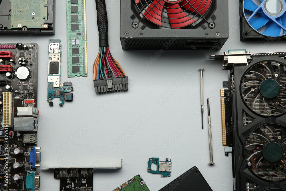 Fototapete frame of graphics card and other computer hardware on light background, flat lay. space for text