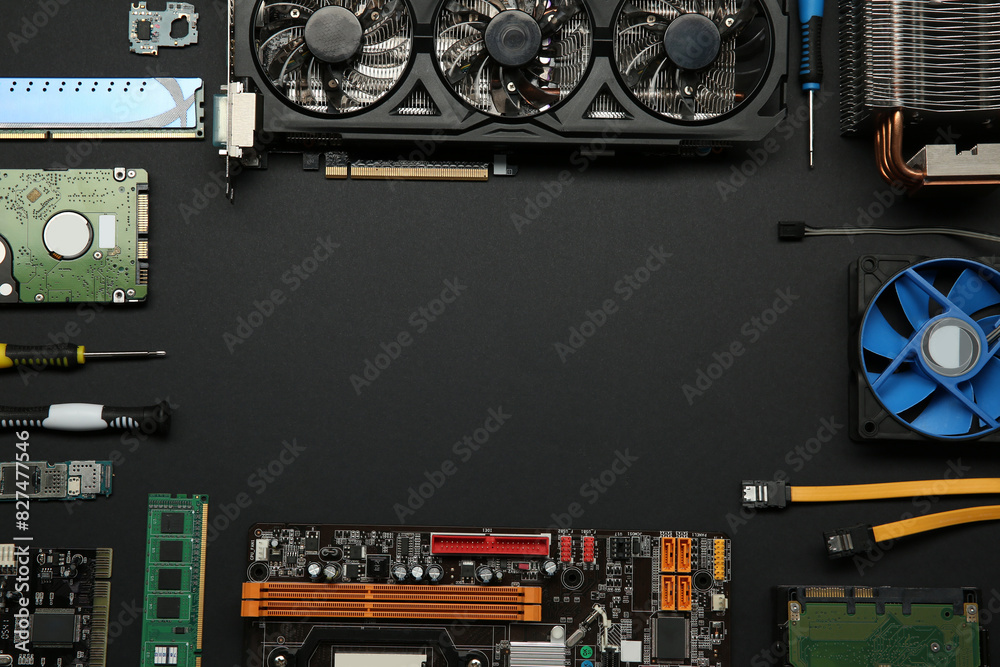 Poster frame of graphics card and other computer hardware on black background, flat lay. space for text
