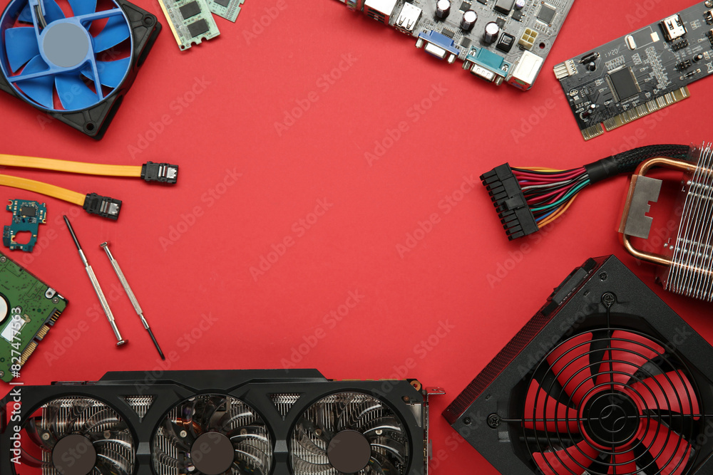 Fototapete frame of graphics card and other computer hardware on red background, flat lay. space for text