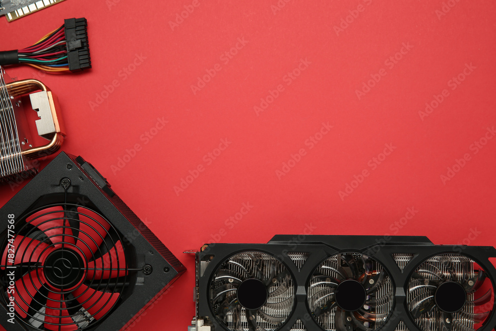 Fototapete graphics card and other computer hardware on red background, flat lay. space for text