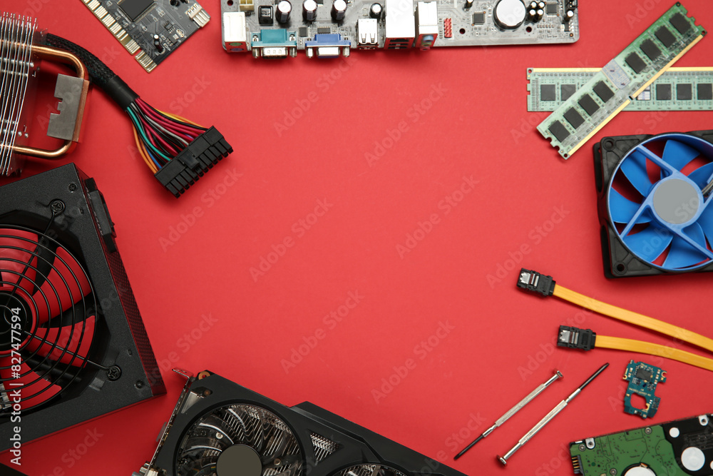 Fototapete frame of graphics card and other computer hardware on red background, flat lay. space for text