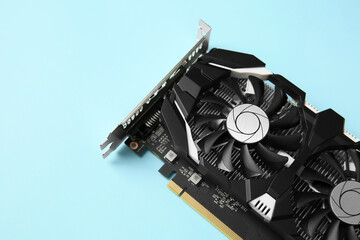 Computer graphics card on light blue background, above view. Space for text