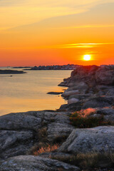 Beautiful sunset on the lake near the rocks. Lake in a small town in Sweden.