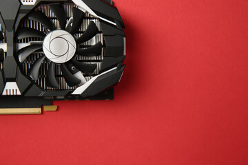 Computer graphics card on red background, top view. Space for text