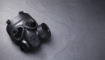 One gas mask on grey textured background, top view. Space for text