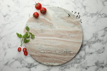 Cutting board, parsley, pepper and tomatoes on white marble table, flat lay. Space for text