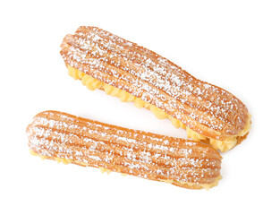 Delicious eclairs filled with cream isolated on white, top view