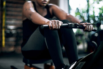 Black woman, row machine and hands for fitness, training and gym for sports workout. Exercise,...