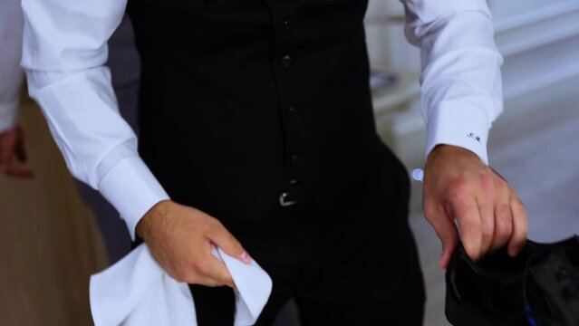 unrecognizable groom getting ready, shinning Patent Leather Shoe with white cloth 60fps