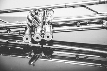 Classical trumpet on black glass table with white background; perfect shot for music lovers...