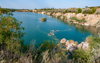 View of the flooded granite quarry with turquoise clear water, Ukraine