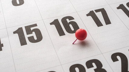16th of the month on the calendar marked with a red pin. Sixteenth day of the month marked with a...