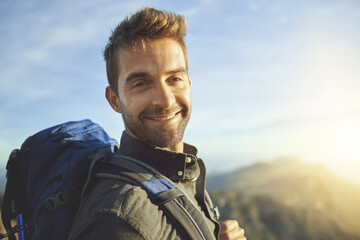 Portrait, mountains and hiking with man, journey and happiness with nature, sunshine and getaway...