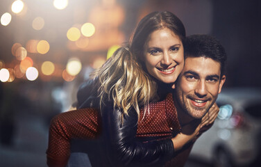 Couple, portrait and piggyback on city street or happy date with bokeh lights at night, romance or...