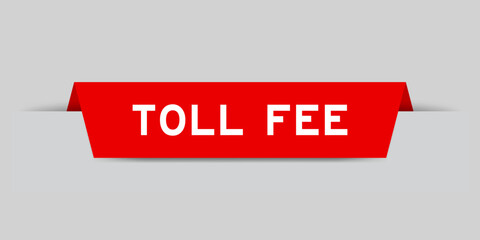 Red color inserted label with word toll fee on gray background