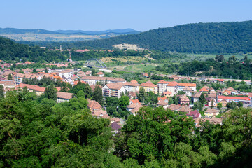 Landscape with view over houses of Sighisoara city, in Transylvania (Transilvania) region of Romania, in a sunny summer day.