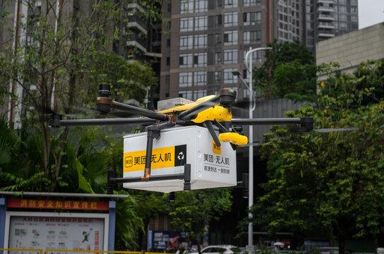 SHENZHEN, CHINA - APRIL 24, 2024: Lunch and meal delivery by drone or multicopter using the Meituan app. The future of order delivery in Shenzhen City
