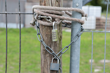 Padlock combination lock with chain on the fence