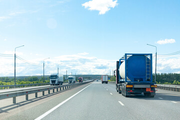 Petrol cargo truck driving on highway hauling oil products. Fuel delivery transportation and...