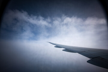 the serene beauty from an airplane window, featuring the wing silhouetted against an expansive,...