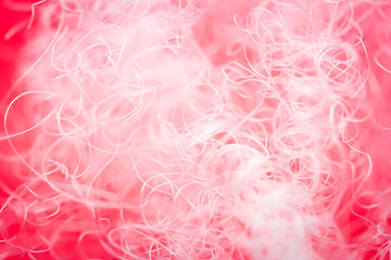 Extreme macro of polyester stable fiber on red background