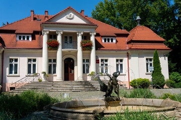 Former villa of director of hard coal mine Saturn in neoclassical style, fountain with boy and swan in foreground. Czeladź, Poland. © aerrant