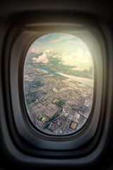 Fototapeta premium the serene beauty from an airplane window, featuring the wing silhouetted against an expansive, cloud-filled sky, instilling a sense of height and peacefulness.