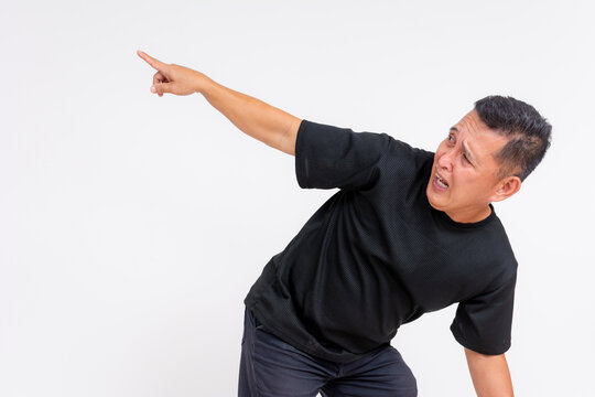 A middle aged man points at a scary guy or monster cowering down looking fearful for his life