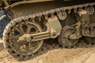 Detail of an American tank from World War II. Close-up.   A tank track as it travels over sand.