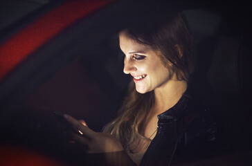 Smile, woman and smartphone in car at night with transport for travel with technology for...