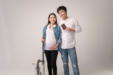 Portrait of Beautiful pregnant woman and husband traveling over white background studio, insurance and maternity concept