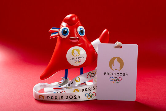 ZHONGSHAN China-May 23 2024: 2024 Paris Olympic Games mascot the Phryge with IC card on red background at horizontal composition.