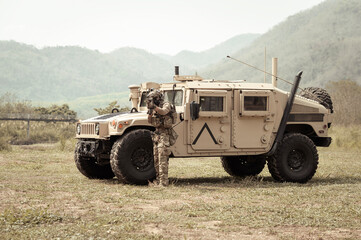 United States Army in camouflage uniforms operation in the forest.with armored vehicle, soldiers...