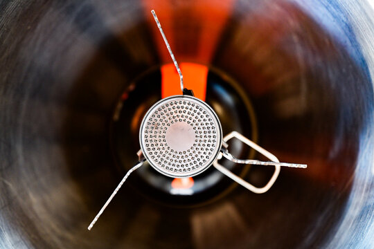 Closeup overhead shot of a camp stove on an isobutane canister, shallow focus
