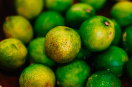 Closeup of a pile of small key limes, shallow focus