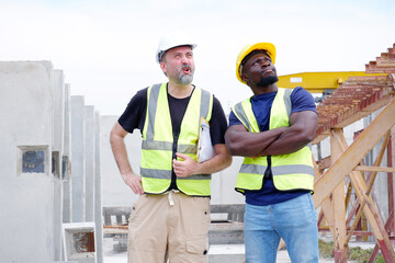 Engineer in safety helmet standing smiling at construction site. Engineer concept.