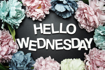 Hello Wednesday alphabet letter with flower decoration on black background © may1985
