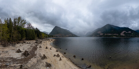 Aerial Canadian Mountain Landscape with lake. Cloudy Rainy Day.