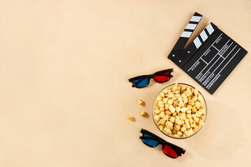 Bowl of popcorn and 3D glasses for watching movies, clapboard. Top view, copy space.