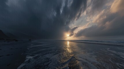 The sky is dark and cloudy, and the ocean is calm. The sun is setting, casting a warm glow over the water