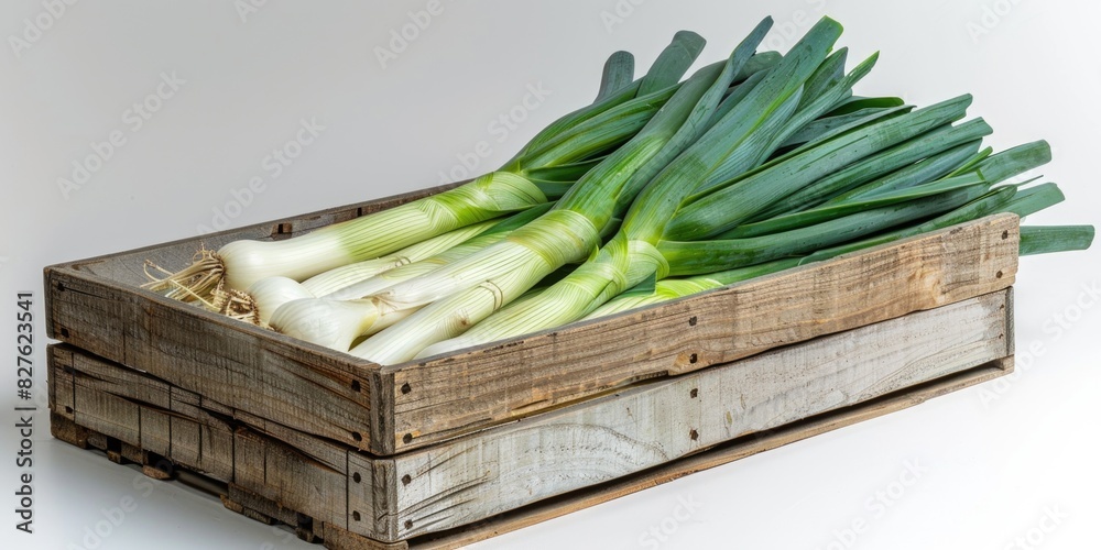 Wall mural a wooden crate filled with green onions. the crate is on a white background. the onions are fresh an