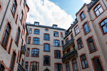 A building with many windows and a balcony. Courtyard of an old building.