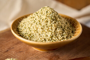 Shelled hemp seeds in a bowl with spoon