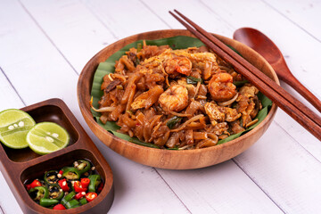 Close up of char kway teow fried flat noodle with condiment