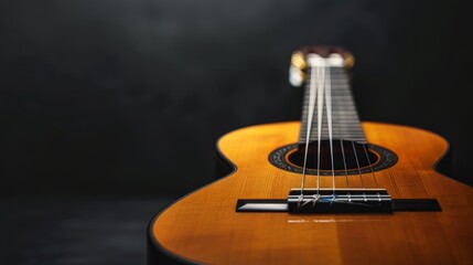 Fototapeta premium Acoustic guitar on a black background (with copy space)