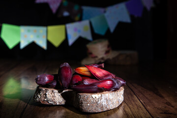 Pine nuts on a wooden table and blurred flags in the background. June festival, typical of winter...